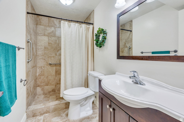 373 East Alexander Drive Elk Ridge, UT 84651 - Photo 43 of 69 Walk-in shower with natural stone-look tile surround and grab bars