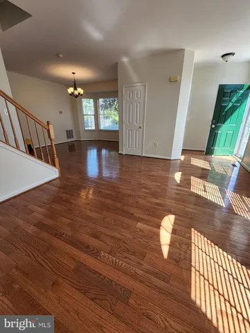 a view of a living room and kitchen with furniture wooden floor