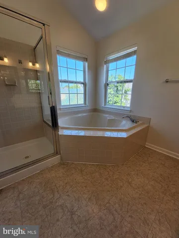 a view of water heater room with a bathtub