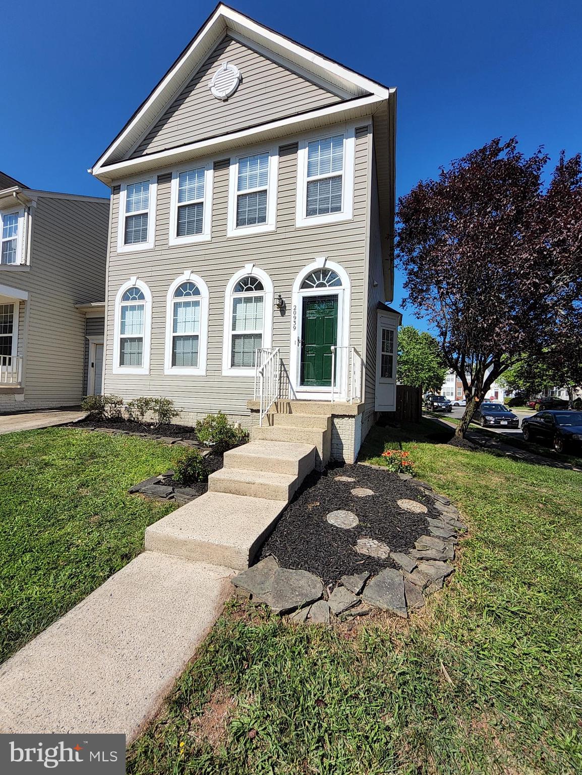 20939 Calais Terrace Ashburn, VA 20147 - Photo 2 of 31 a front view of a house with a yard