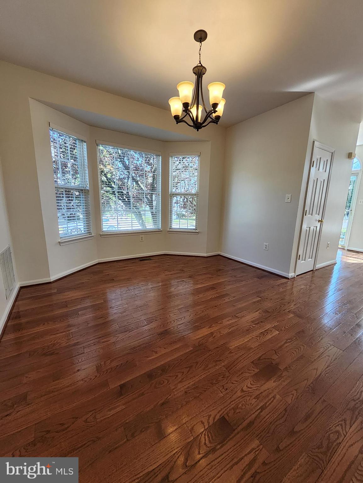 20939 Calais Terrace Ashburn, VA 20147 - Photo 8 of 31 a view of an empty room with wooden floor and a window