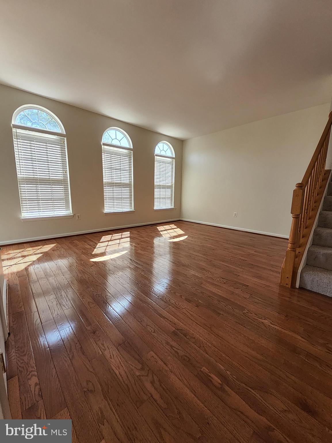 20939 Calais Terrace Ashburn, VA 20147 - Photo 9 of 31 a view of an empty room with wooden floor and a window
