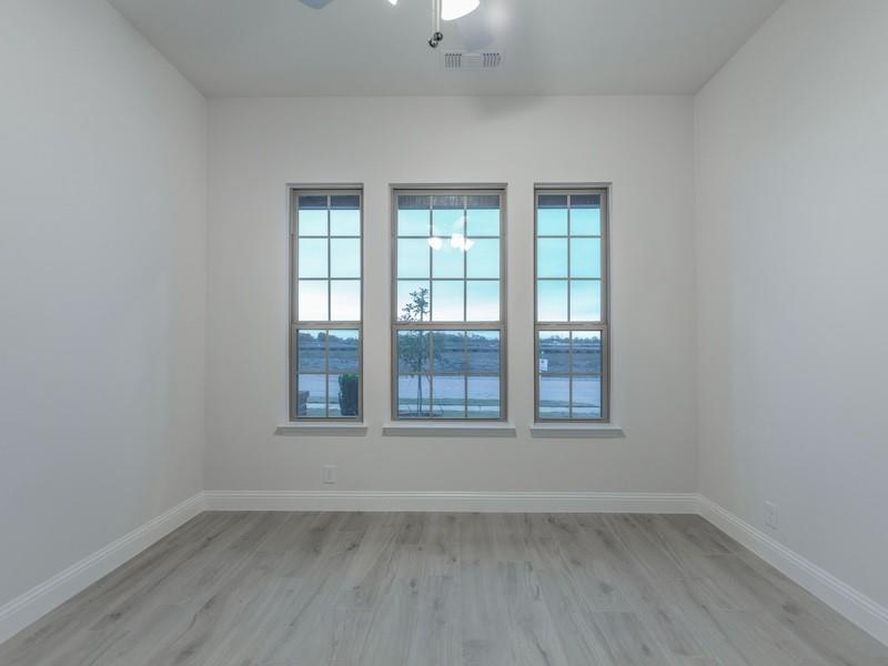 151 Winterwood Drive Lavon, TX 75166 - Photo 5 of 22 an empty room with wooden floor and windows