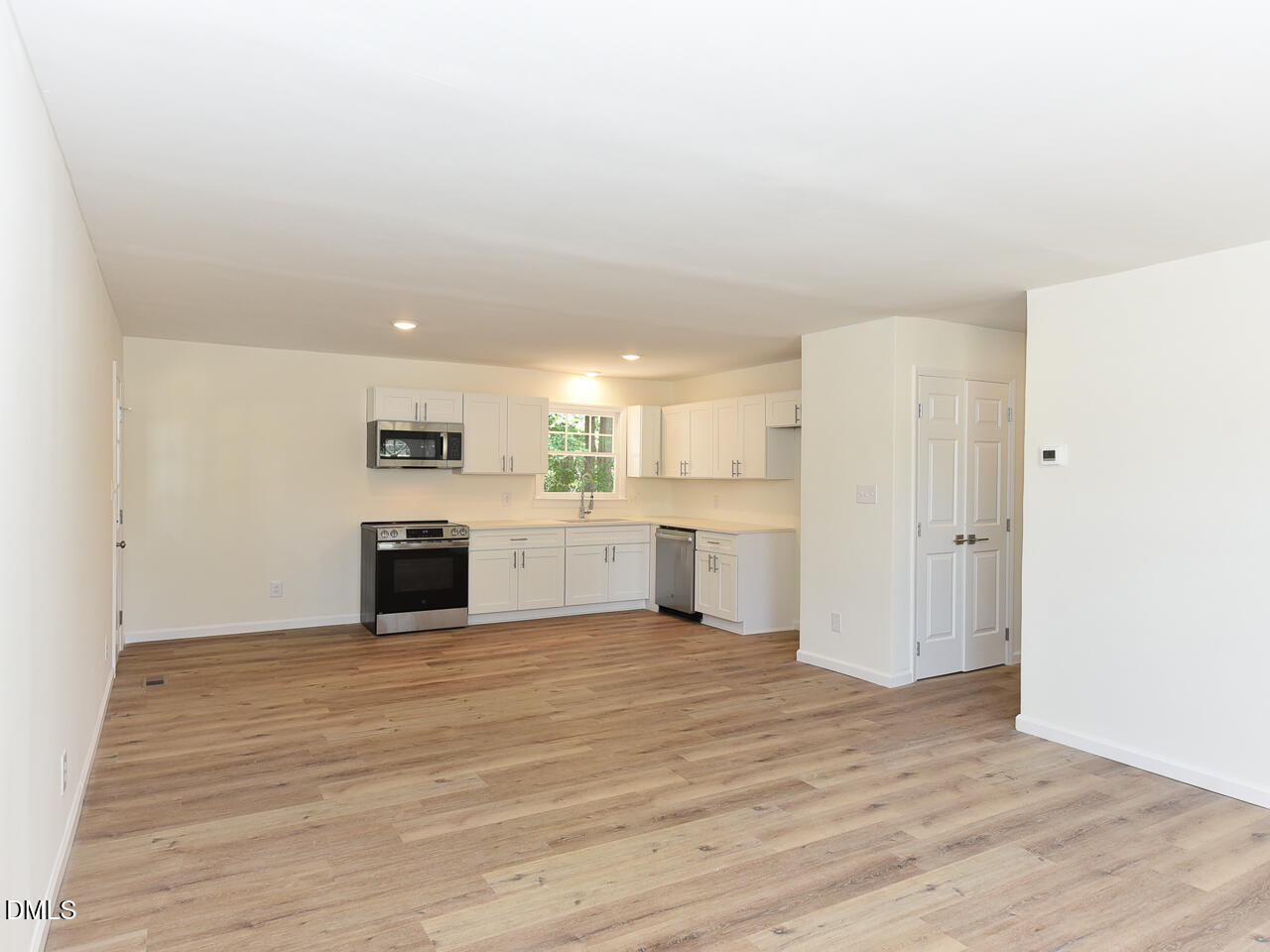939 Cheves Road Zebulon, NC 27597 - Photo 7 of 21 a large white kitchen with white cabinets and a stainless steel appliances