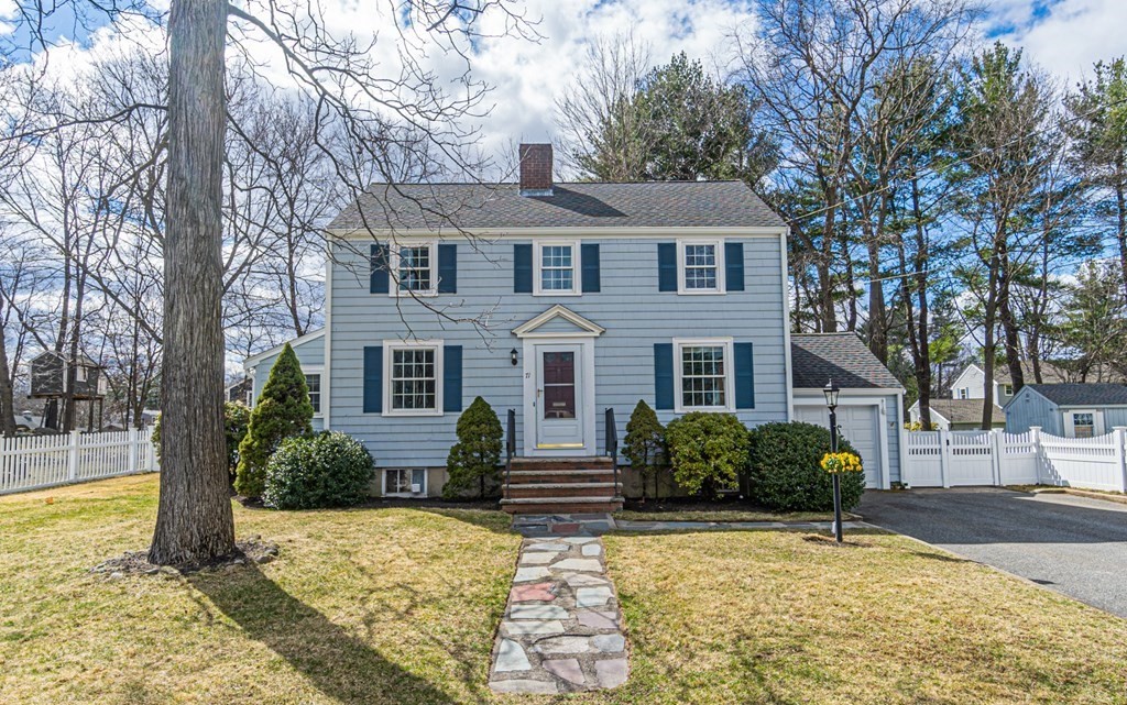 71 Pine Ridge Road Reading, MA 01867 - Photo 1 of 40 a front view of a house with a yard and garage