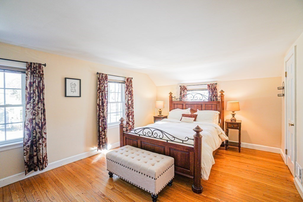 71 Pine Ridge Road Reading, MA 01867 - Photo 16 of 40 a bedroom with a bed and wooden floor