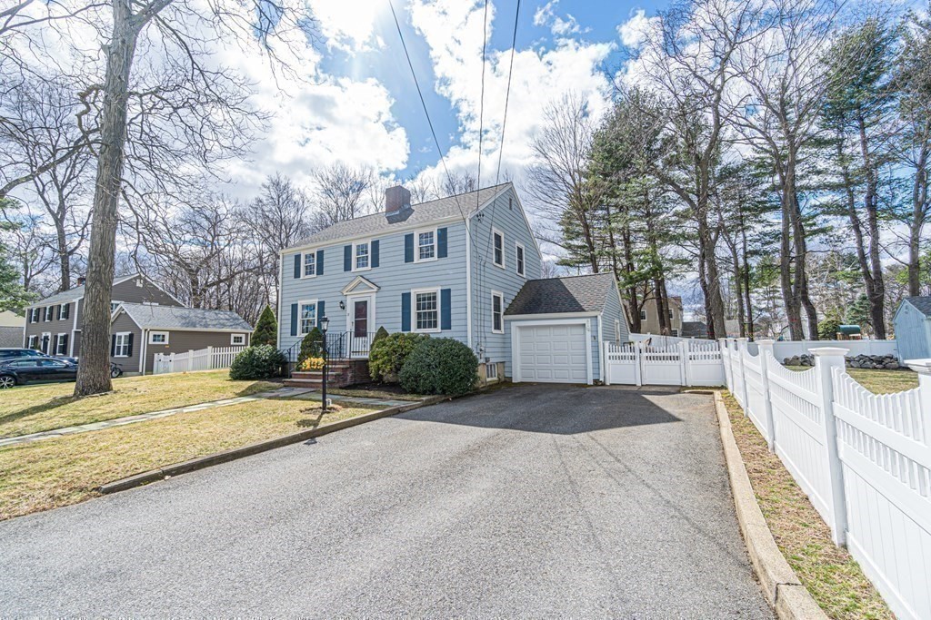 71 Pine Ridge Road Reading, MA 01867 - Photo 29 of 40 a view of house with yard and trees in the background