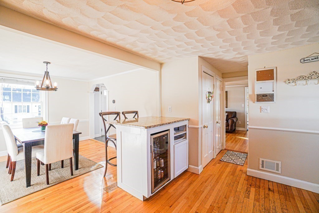 71 Pine Ridge Road Reading, MA 01867 - Photo 4 of 40 a kitchen with a stove and white cabinets with wooden floor