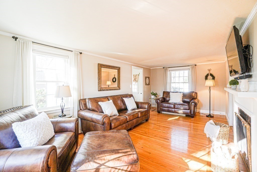71 Pine Ridge Road Reading, MA 01867 - Photo 8 of 40 a living room with furniture large window and a flat screen tv
