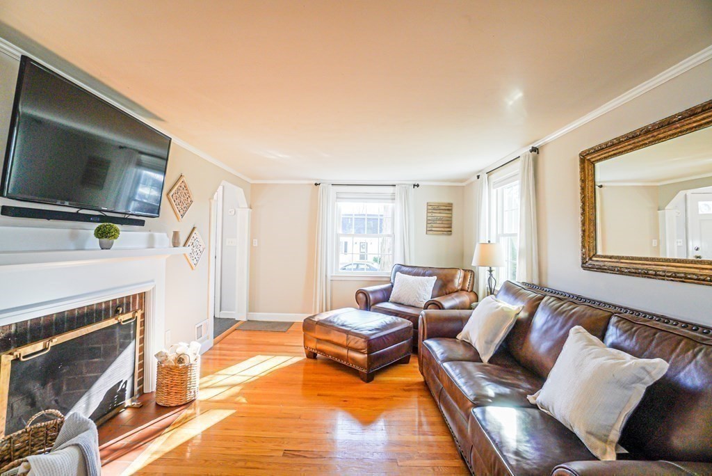 71 Pine Ridge Road Reading, MA 01867 - Photo 9 of 40 a living room with furniture and a flat screen tv
