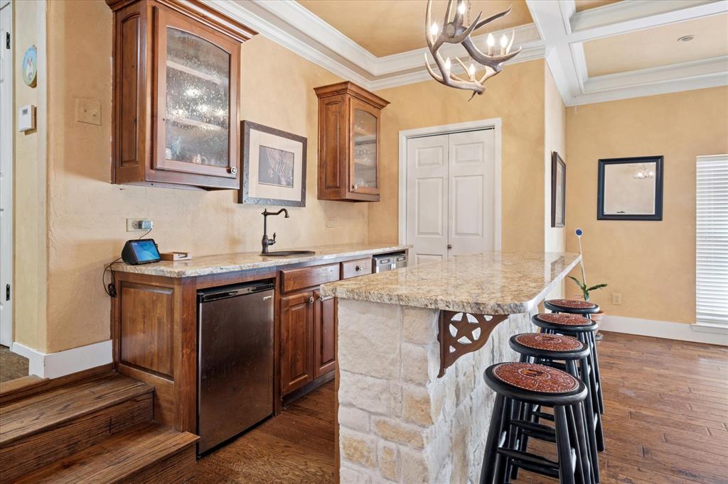 6941 Burger Road Aubrey, TX 76227 - Photo 4 of 28 Located in Family Room this beautiful bar with cabinetry is a great gathering spot!