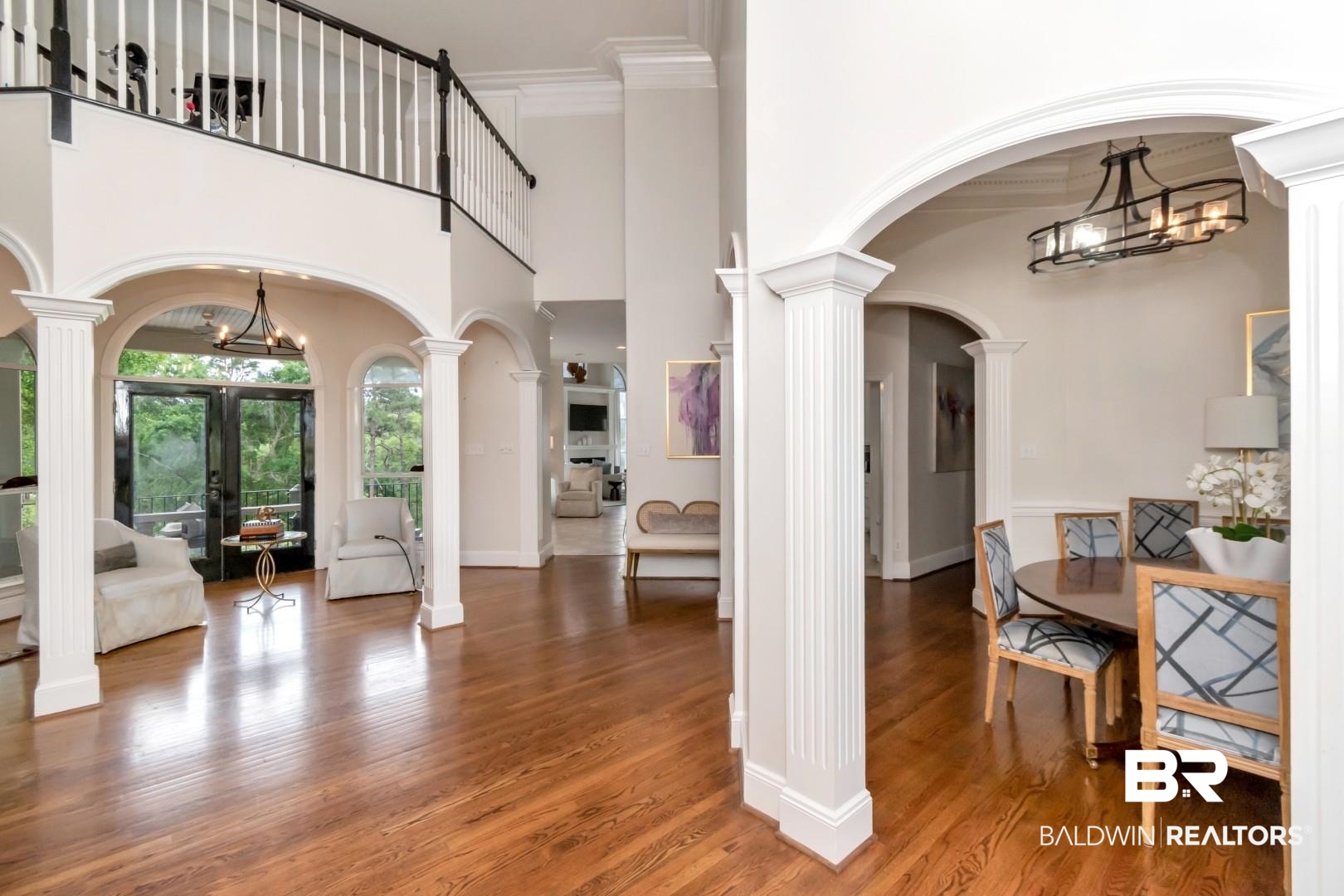 2640 Meadowlake Road Semmes, AL 36575 - Photo 6 of 55 Entrance foyer with arched walkways, hanging lights, crown molding, a high ceiling, and ornate columns
