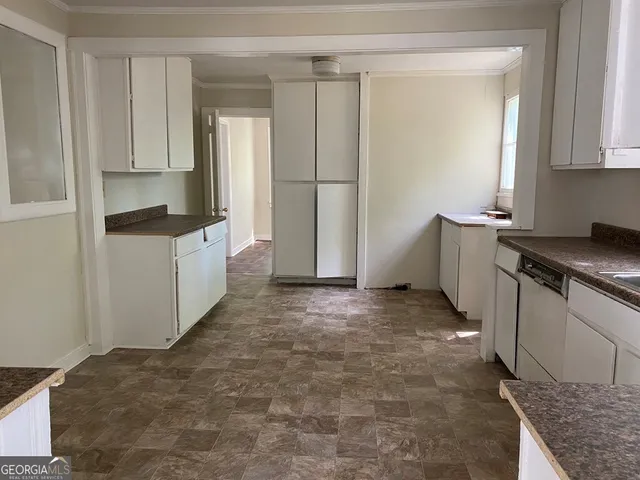 a kitchen with stainless steel appliances granite countertop a refrigerator and a stove