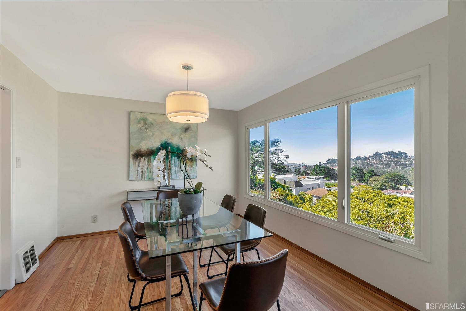 159 Skyview Way San Francisco, CA 94131 - Photo 6 of 17 a view of a dining room with furniture a chandelier and wooden floor