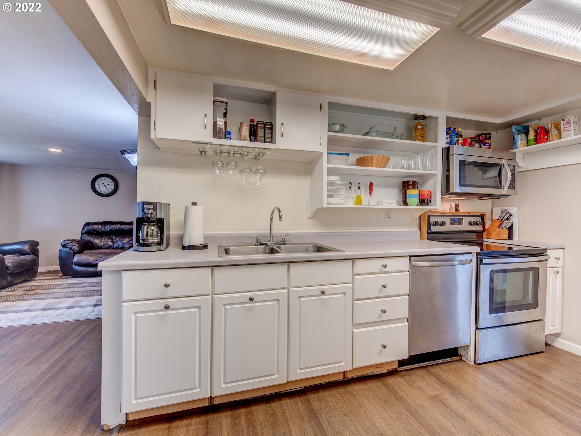1177 N Street Springfield, OR 97477 - Photo 11 of 30 a kitchen with cabinets a sink and wooden floor