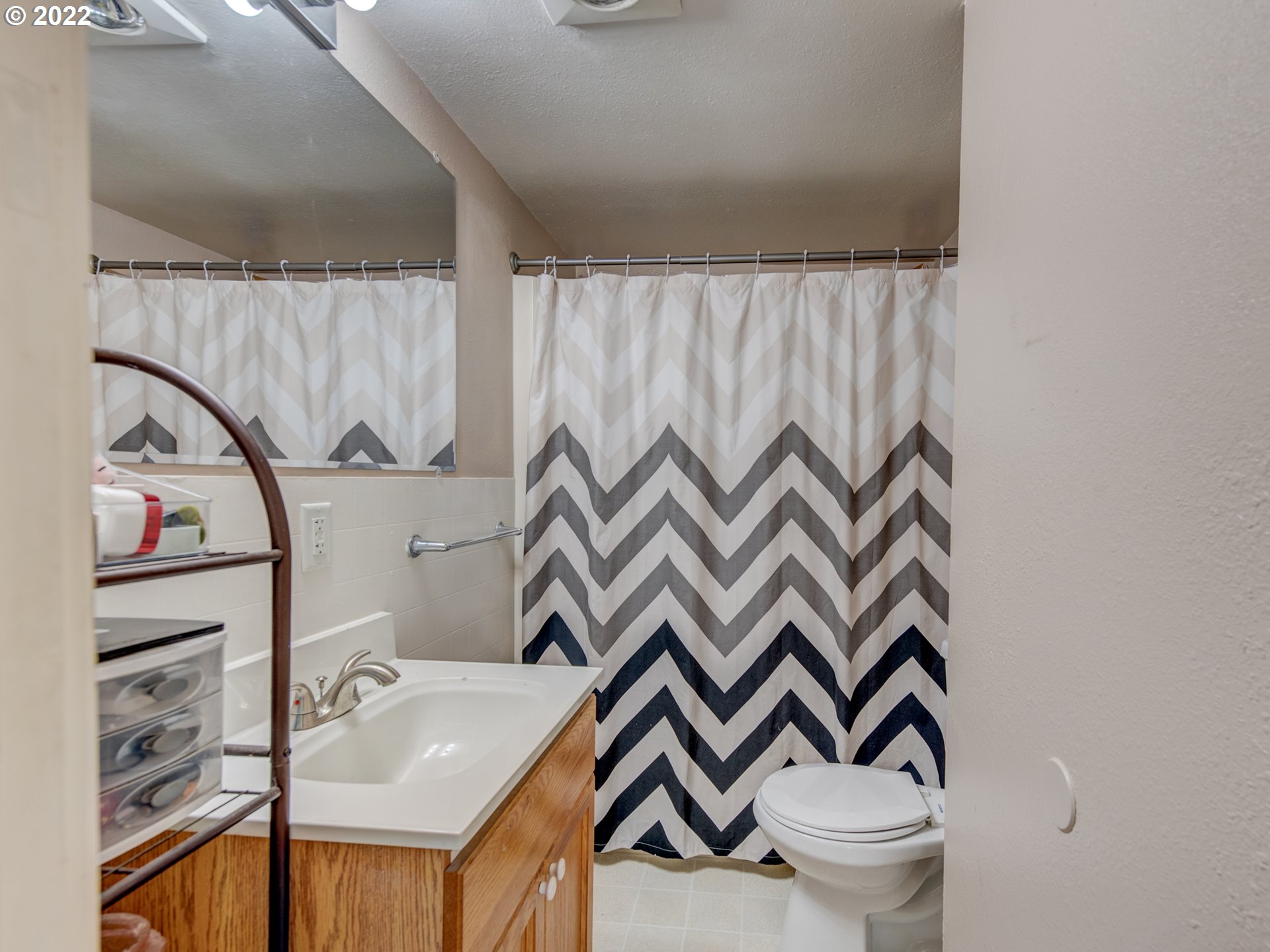 1177 N Street Springfield, OR 97477 - Photo 18 of 30 a bathroom with a sink a toilet and a mirror