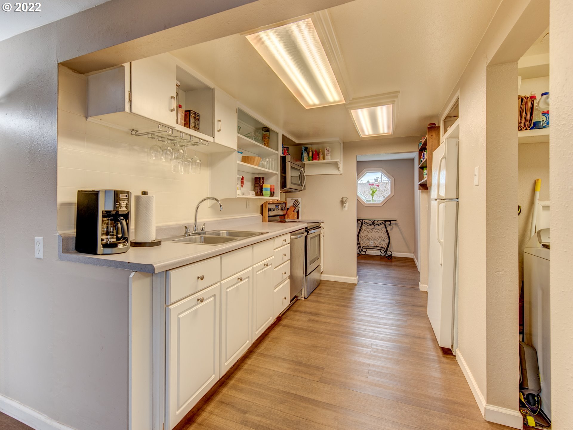 1177 N Street Springfield, OR 97477 - Photo 9 of 30 a kitchen with cabinets a sink and wooden floor