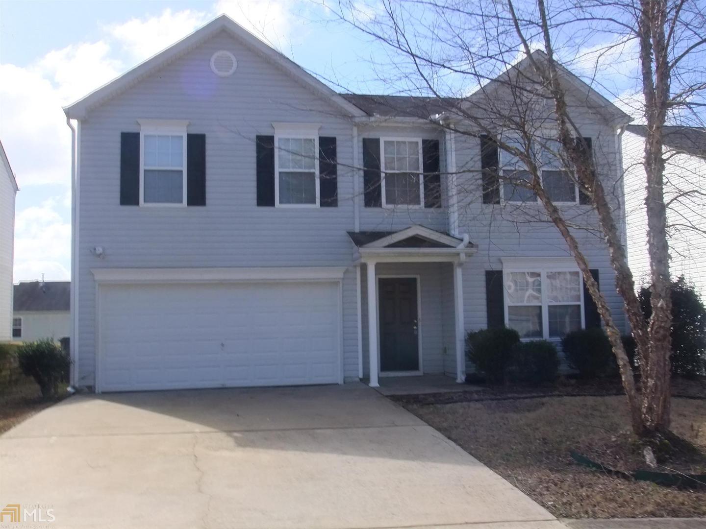 3506 Devon Chase Road, Unit /78 Atlanta, GA 30349 - Photo 1 of 1 a front view of a house with a yard and garage