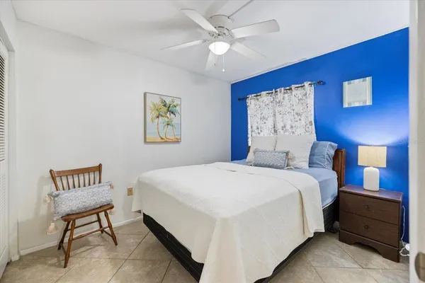 a spacious bedroom with a bed and a table in it