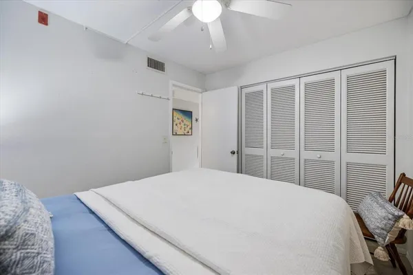 a bedroom with a large bed and a chandelier