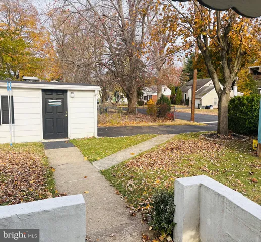 a view of house with pool and yard