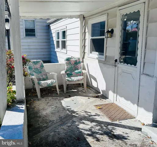 a building outdoor space with patio furniture and potted plants