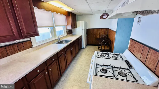 a view of kitchen and utility room with wooden floor
