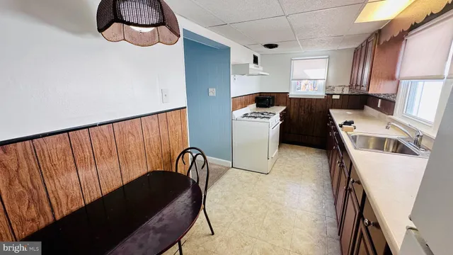 a kitchen with stainless steel appliances granite countertop a stove a sink a refrigerator and a microwave