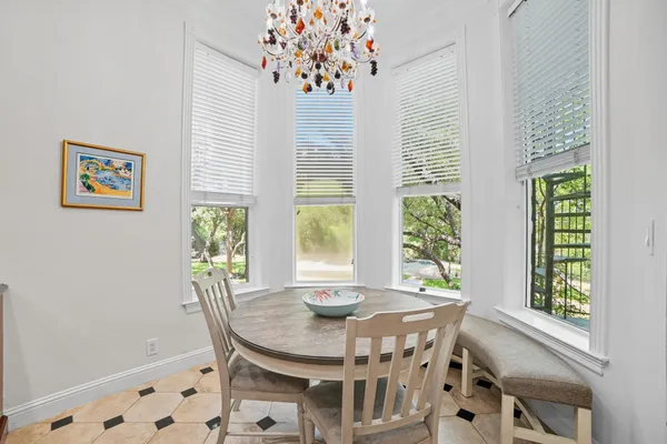 a view of a dining room with furniture and a window
