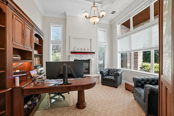 a living room with furniture a table and a fireplace