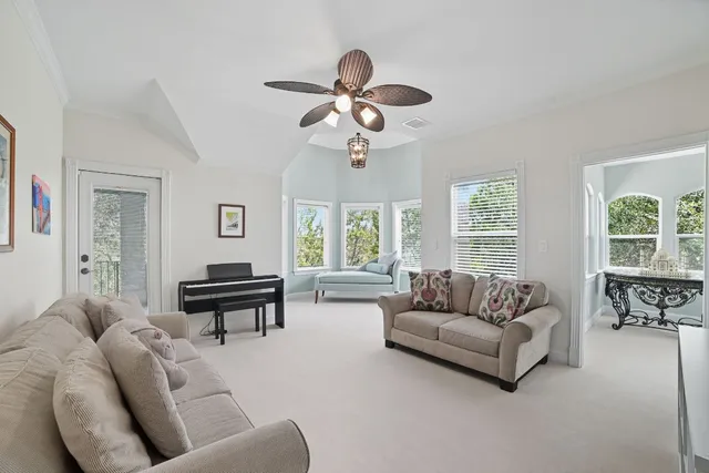 a dining room with furniture a rug and a large window
