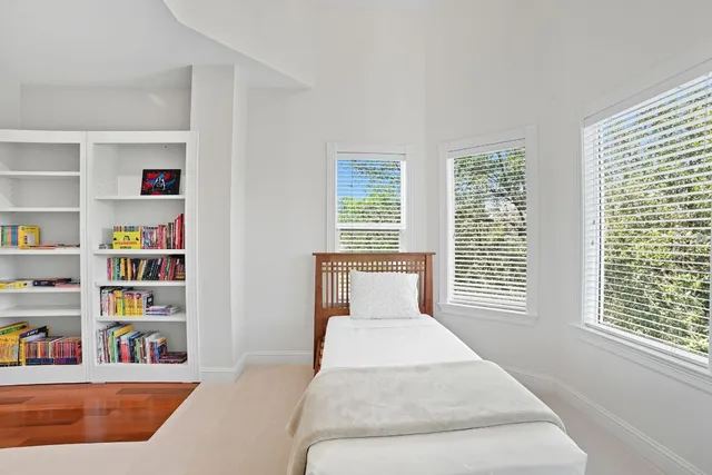 a utility room with lots of clutter and cabinets