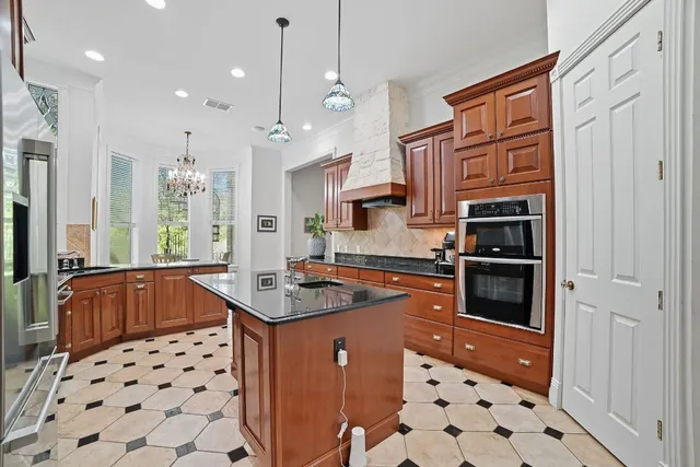a kitchen with stainless steel appliances a stove a sink and a refrigerator
