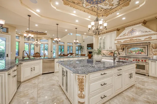 a large kitchen with a lot of counter space and a chandelier