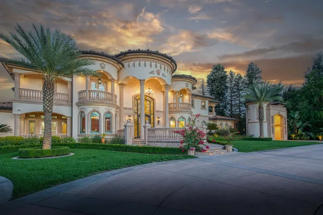 a front view of multiple houses with yard