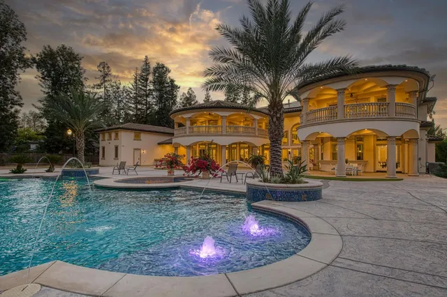 a view of a backyard with swimming pool