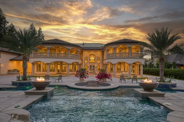 a view of a house with a backyard and a patio