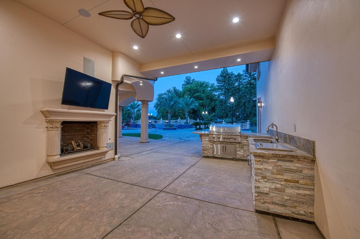 6060 North Van Ness Boulevard Fresno, CA 93711 - Photo 25 of 26 a living room with furniture and a fireplace