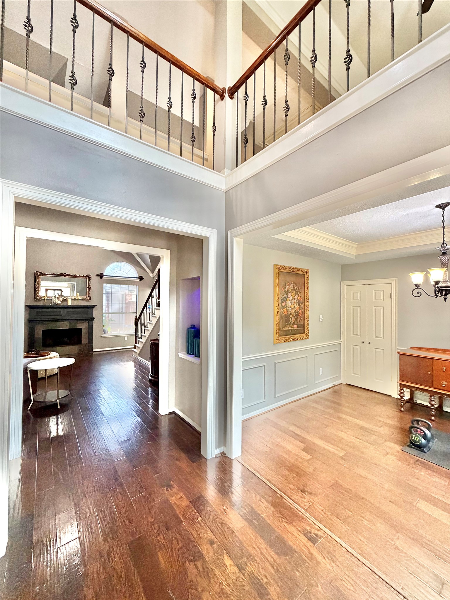 20110 Forest Drive Spring, TX 77388 - Photo 5 of 43 Step into an inviting open foyer with elegant wood flooring and a view of the spacious living area that effortlessly flows into a cozy dining space, perfect for welcoming guests.