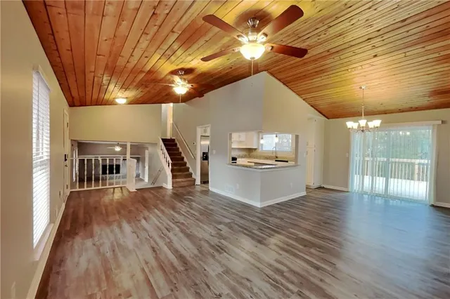 a view of a kitchen with a sink and wooden floor