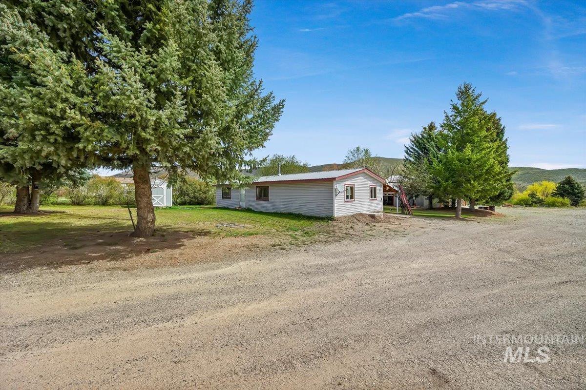 102 Willow Creek Road Fairfield, ID 83327 - Photo 2 of 32 View of side of home with a storage unit and a yard