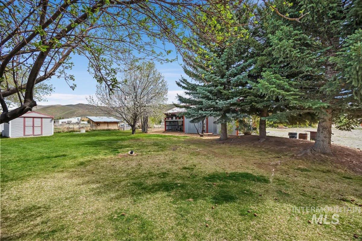 102 Willow Creek Road Fairfield, ID 83327 - Photo 26 of 32 View of grassy yard with a storage unit