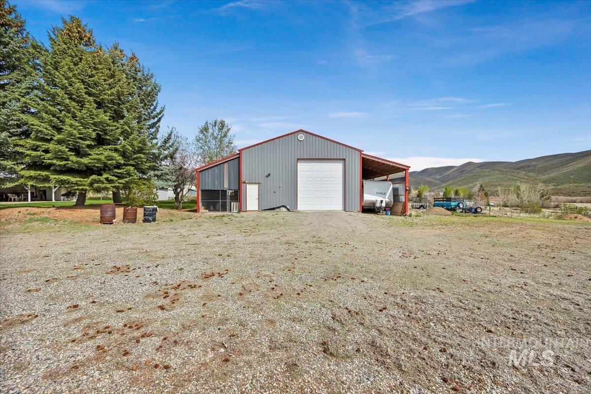 102 Willow Creek Road Fairfield, ID 83327 - Photo 30 of 32 Garage with a garage, a mountain view, and driveway