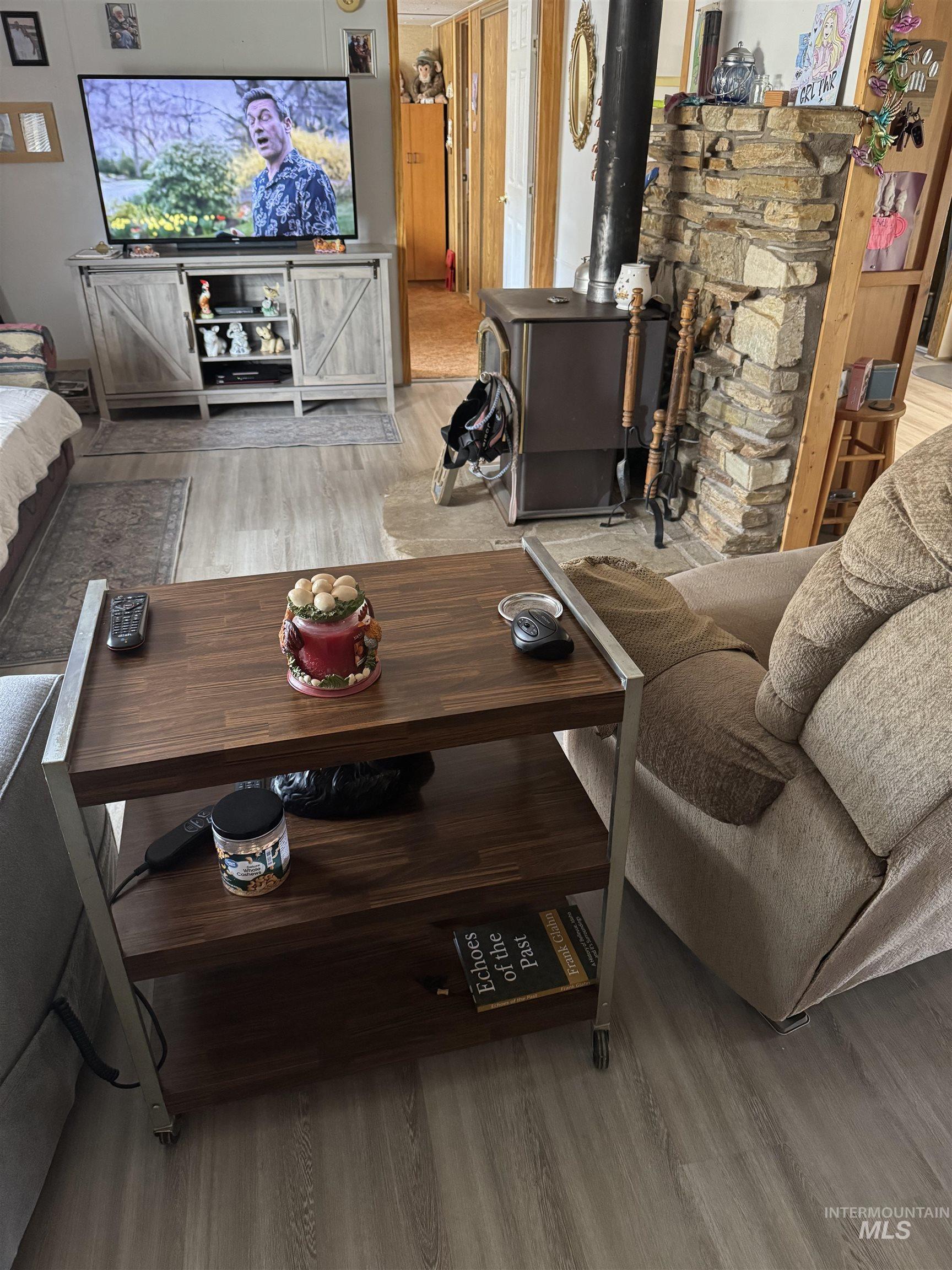 102 Willow Creek Road Fairfield, ID 83327 - Photo 38 of 40 Living area featuring light wood-type flooring and a wood stove