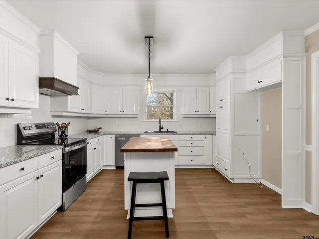 a bathroom with a granite countertop sink and dishwasher