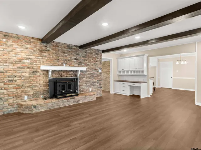 a view of an empty room with a fireplace