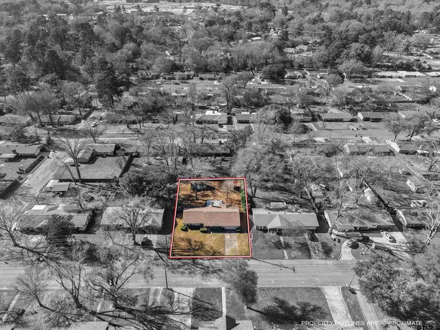 an aerial view of a house with a yard