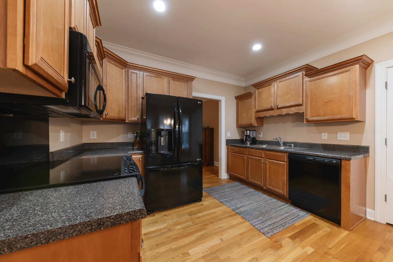 1014 Meeks Cemetery Road Burns, TN 37029 - Photo 10 of 33 a kitchen with granite countertop a sink stainless steel appliances and cabinets