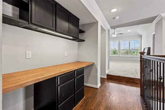 a kitchen with stainless steel appliances granite countertop a refrigerator a sink dishwasher a stove and white cabinets with wooden floor