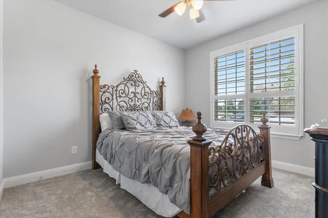 a bed sitting in a bedroom next to a window